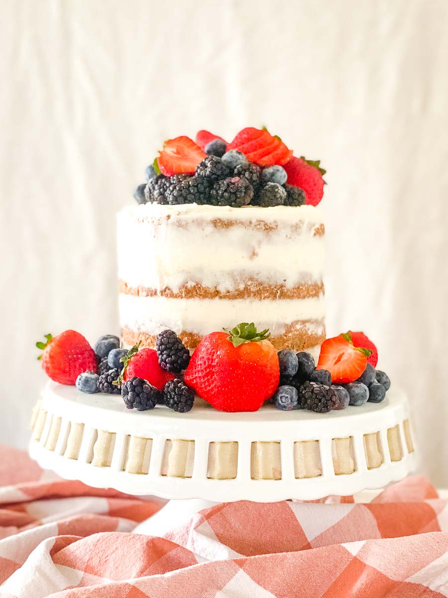 Carrot Zucchini layer cake with cream cheese frosting and decorated with fresh berries